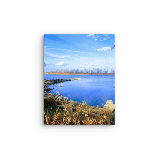 Bright blue river landscape scene with blue sky and brown winter grasses