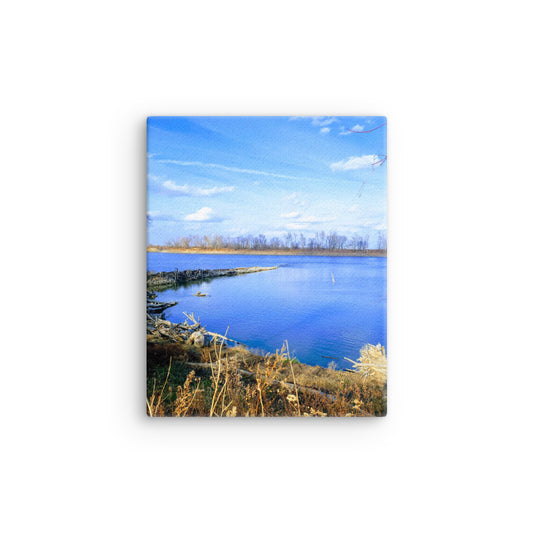 Bright blue river landscape scene with blue sky and brown winter grasses